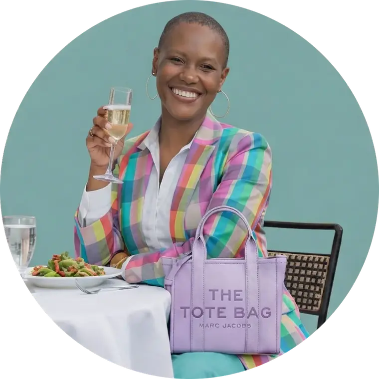 Celeste Angelic London smiling, raising a glass